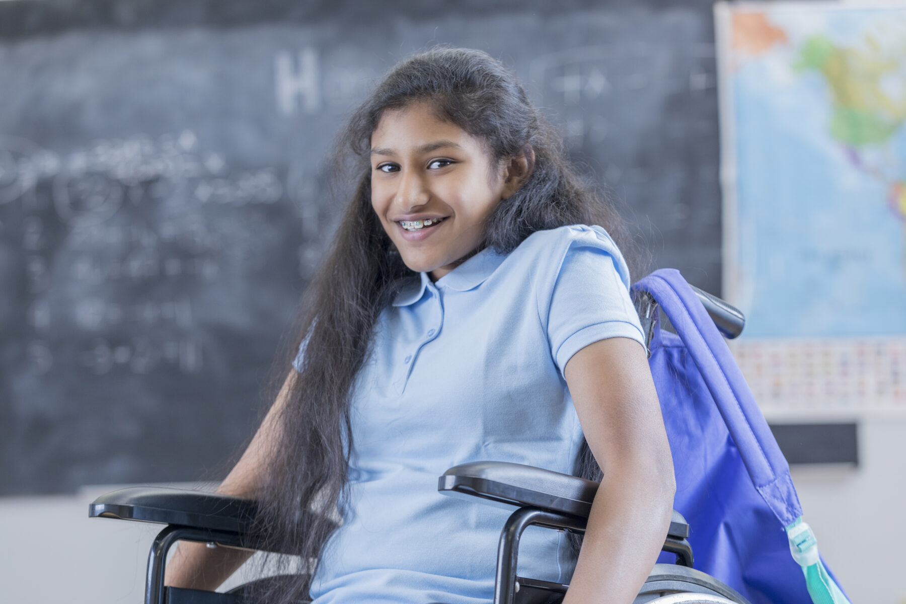 Confident STEM schoolgirl in wheelchair at school